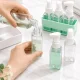 Kelioninių buteliukų rinkinys kosmetikai 4x50 ml su dėklu ir etiketėmis